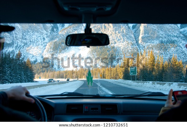 In car view of winter highway driving in the\
mountains in the morning