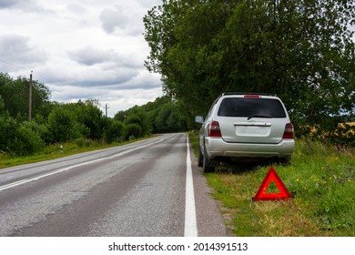 A Car Waiting For Repair After A Breakdown In A Remote Rural Area Outdoors, A Broken Car On The Side Of The Road, An Emergency Stop Sign