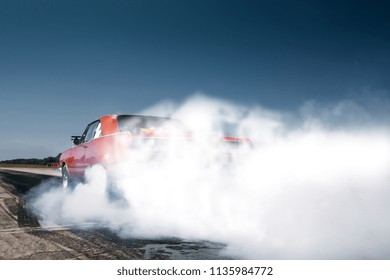 Car warm up with smoke before drag race. Burnout and drift at the starting line