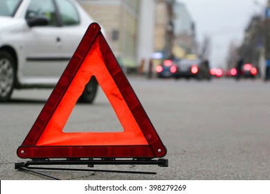 Car Warning Triangle On The Road.