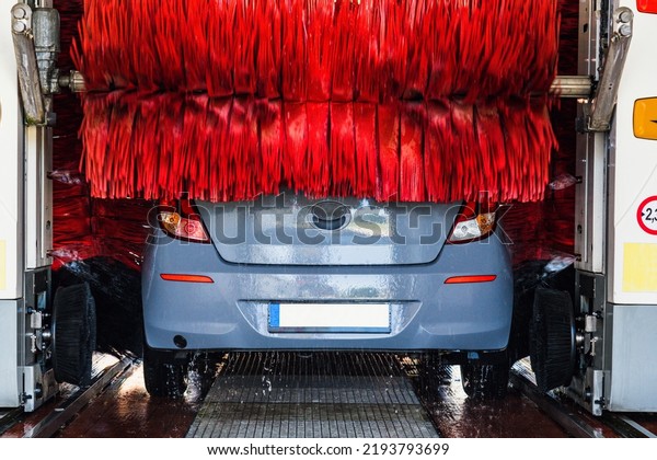 Car wash automatic carwash. Brush washer clean\
blue auto car on automatic car wash station. Auto carwash machine\
background
