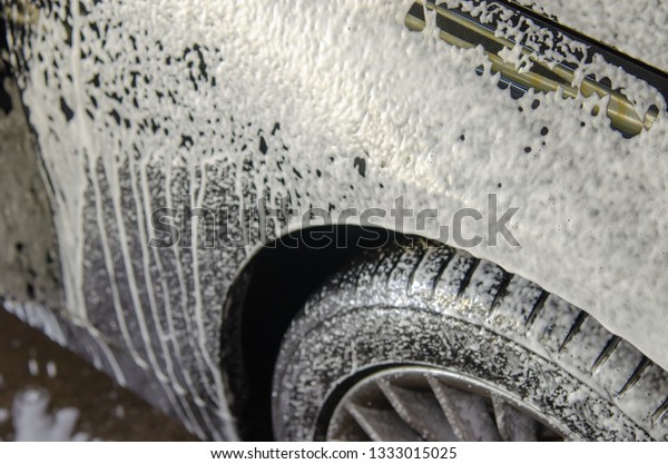 Car wash black with foam\
bubbles