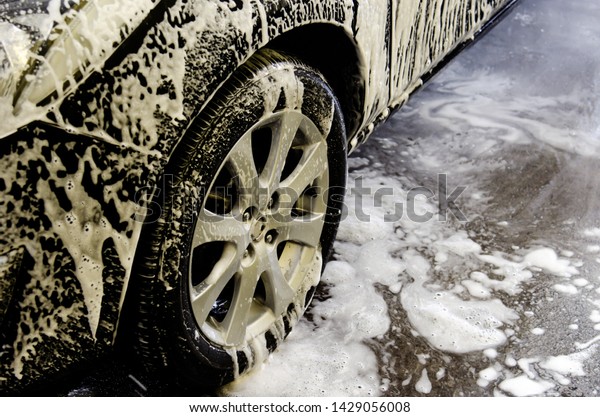 Car wash black with foam\
bubbles