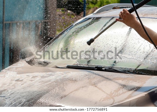 Car wash, Front window washed with a stream of\
water under pressure.