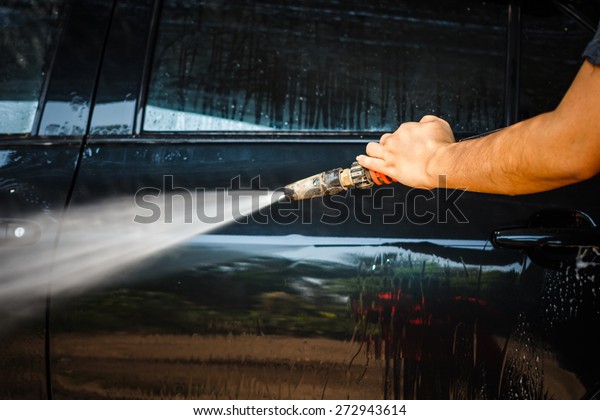 Car wash \
with high pressure cleaners in\
action