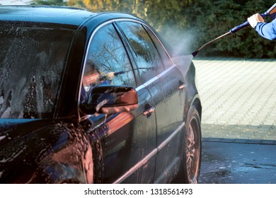 Car Wash High-pressure Apparatus Of Water. Black Car On A Handwash Self-service.