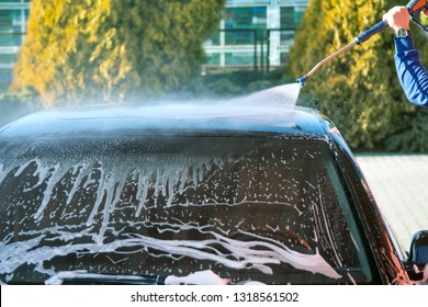 Car Wash High-pressure Apparatus Of Water. Black Car On A Handwash Self-service.