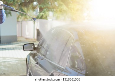 Car Wash High-pressure Apparatus Of Water. Black Car On A Handwash Self-service.