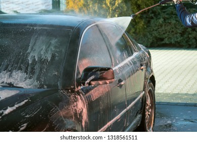 Car Wash High-pressure Apparatus Of Water. Black Car On A Handwash Self-service.