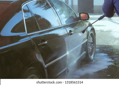 Car Wash High-pressure Apparatus Of Water. Black Car On A Handwash Self-service.