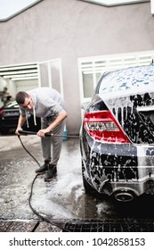 Car wash with pressurized water, car detailing (or valeting) concept. - Shutterstock ID 1042858153