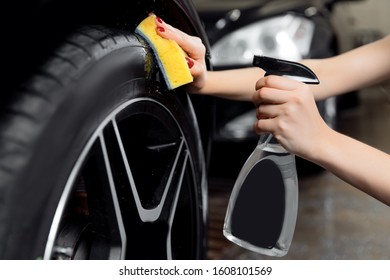 Car Wash Service, Detailing Using Spray And Sponge To Wipe Black Tire.