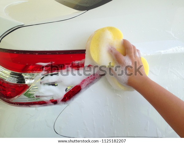 Car Wash with car\
shampoo and sponge. 