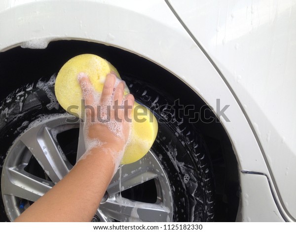 Car Wash with car\
shampoo and sponge. 