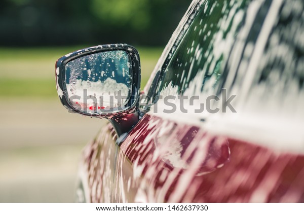 Car wash with\
soap. Manual car wash with pressurized water in car wash\
outside.Summe Washing. Cleaning Car Using High Pressure Water.\
Washing  with soap. Close up concept.\
