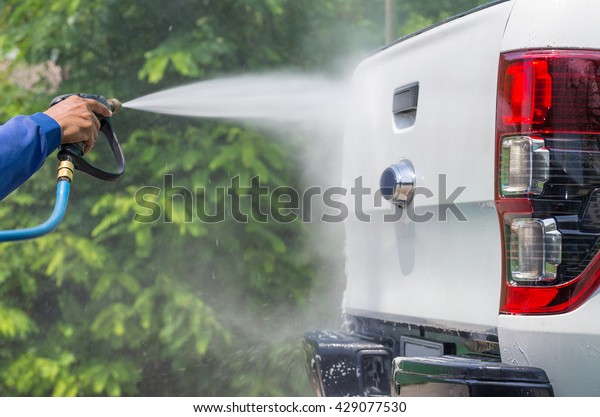 Car wash,\
spray gun with high pressure,\
pickup.