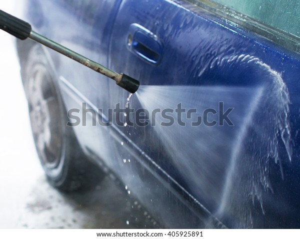 Car wash using high\
pressure water jet.