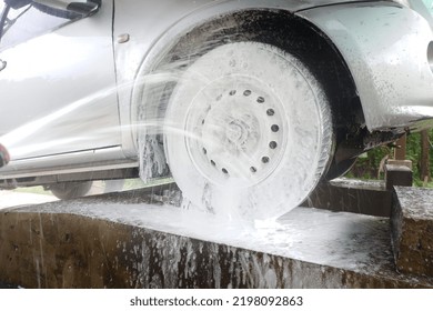 Car Wash Wheels With White Foam On The Raised Floor Of The Car Wash Station.