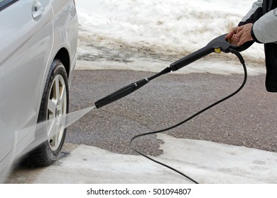 Car Wash In Winter - A Man Washes His Car