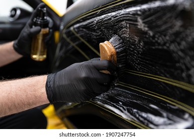 Car Wash Worker Cleaning An Brushing Car Leather Upholstery.