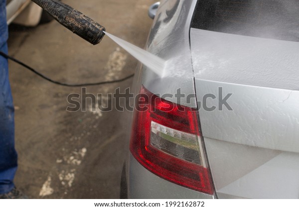 The car is washed at the car wash. Washing the\
car from dirt. High pressure water spraying equipment for washing\
car surfaces.
