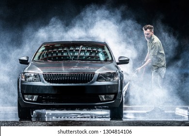 A Car Washer Washes A Gray Car With A High-pressure Washer At Night On The Street. Expensive Advertising Photography