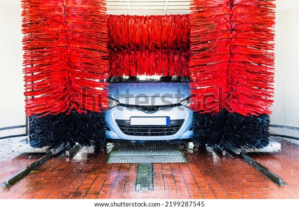 Car\
washing automatic carwash. Brush washer clean blue auto car on\
automatic car wash station. Carwash cleaning\
service