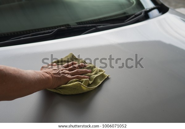 Car washing by hand holding microfiber cloth\
wiped for car care service