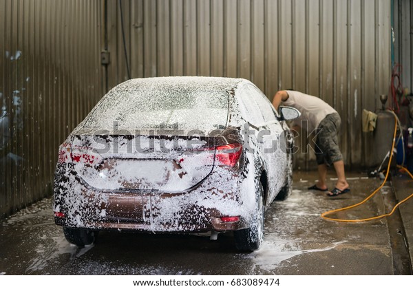 car washing by hand using a foam preparation for\
polishing,selective focus