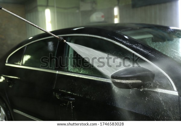 car washing by jet of water close-up. contactless\
car wash