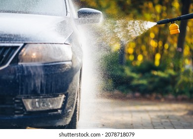 Car Washing With Pressure Washer On Backyard