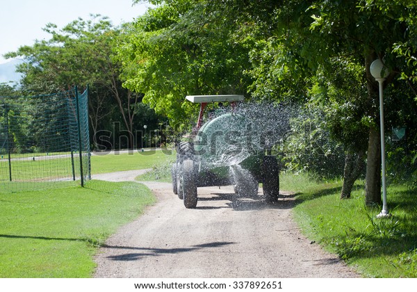 Car watering sand\
path