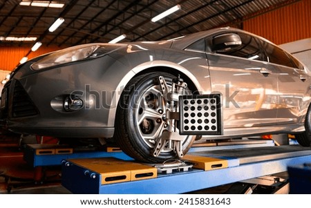 Car wheel alignment is in progress. auto camber toe check fixing. sensor during suspension adjustment and automobile wheel alignment work at the repair service station