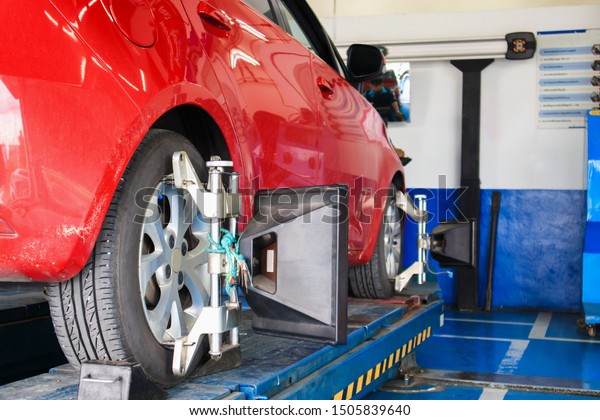 Car wheel alignment in progress at auto repair\
service centre
