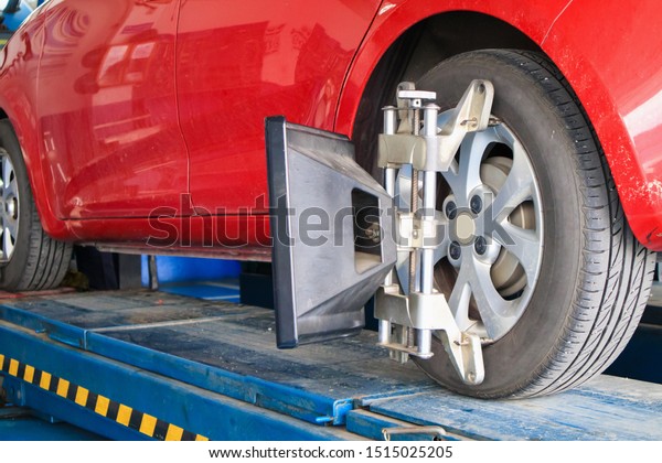 Car wheel alignment in progress at auto repair\
service centre