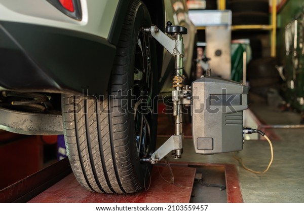 car wheel alignment in progress at auto repair\
service station