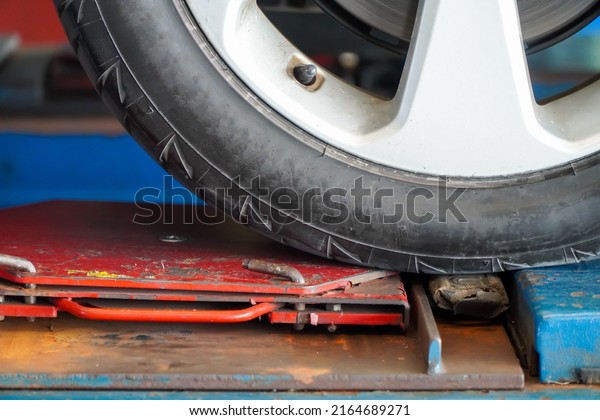 Car wheel alignment service,Wheel alignment work\
at repair service station