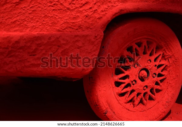 A car wheel and body applied with a red pigment\
made from powdered red lead