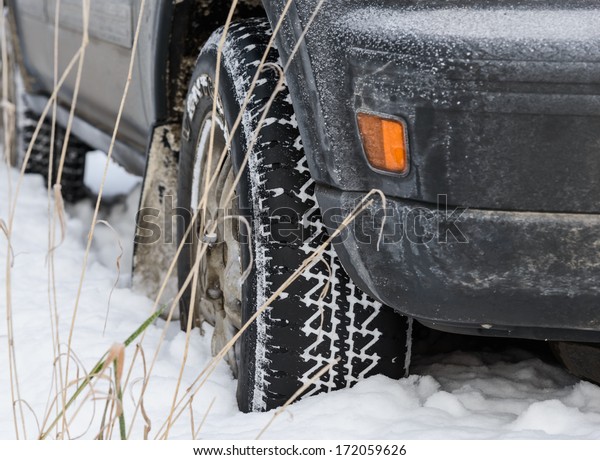 car wheel in deep\
winter snow snowbank
