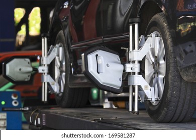 Car Wheel Fixed With Computerized Wheel Alignment Machine Clamp.