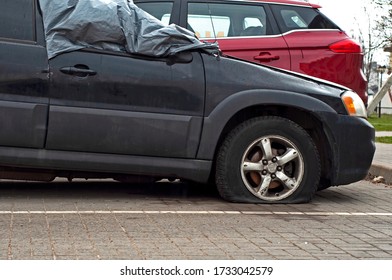 Car Wheel Flat Tire On The Road. Road Accident