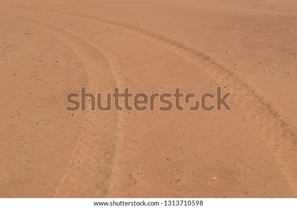 car wheel marks on desert\
