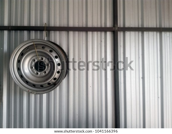 Car wheel on the wall ,
metal sheet