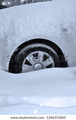 car wheel in the snow as a symbol of winter