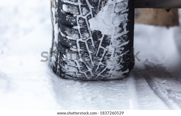 Car wheel in the snow.\
Winter