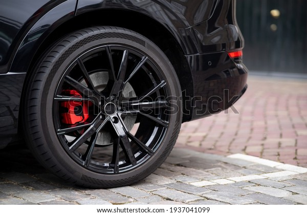 Car wheel and tire red breaks vehicle\
black sport alloy shiny automobile\
Monaco
