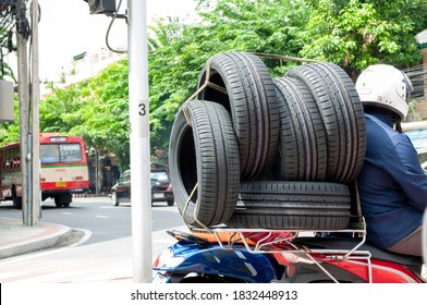 Car wheel transport By motorcycle,motorcycle courier, transporting automobile rubber tires