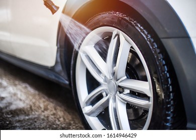 Car Wheel Wash. Car Cleaning With Water Jet. Car Rim Or Aloy Washing Close Up.