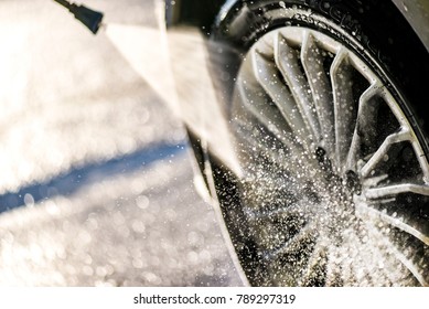 Car Wheel Washing. Car Cleaning With Water Jet. Car Rim Wash Close Up. 