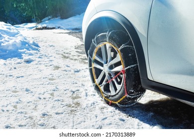 Car wheel with winter chains for snow and ice road on it close-up image